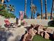 Relaxing backyard featuring a desert landscape with a firepit and sun loungers at 1704 Cordoba Canyon St, Las Vegas, NV 89117