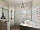 Walk-in shower and soaking tub, with block window providing natural light in the bathroom at 1704 Cordoba Canyon St, Las Vegas, NV 89117