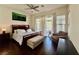 Bedroom with wood floors, ceiling fan, and a large window at 1704 Cordoba Canyon St, Las Vegas, NV 89117