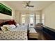 Bedroom with wood floors, ceiling fan, and a large window at 1704 Cordoba Canyon St, Las Vegas, NV 89117