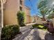 Charming front yard with a tiled pathway, lush greenery, and a tranquil fountain at 1704 Cordoba Canyon St, Las Vegas, NV 89117