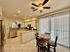 Well-lit kitchen featuring a breakfast bar, stainless steel appliances, and a dining area by sliding glass doors at 1704 Cordoba Canyon St, Las Vegas, NV 89117