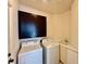 Functional laundry room with washer, dryer, and built-in cabinets for storage at 1704 Cordoba Canyon St, Las Vegas, NV 89117