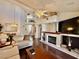Comfortable living area featuring a fireplace, hardwood floors, and plenty of natural light at 1704 Cordoba Canyon St, Las Vegas, NV 89117