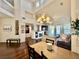 Open-concept living space with a cozy fireplace, hardwood floors, and a view of the staircase at 1704 Cordoba Canyon St, Las Vegas, NV 89117