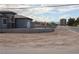 Exterior side-view of a new home under construction on a sunny day, with nearby high-rise buildings at 197 E Shelbourne Ave, Las Vegas, NV 89123