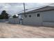 Exterior view of home and detached garage, stone yard, and block wall at 197 E Shelbourne Ave, Las Vegas, NV 89123