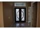 Inviting foyer featuring a decorative double door entry with elegant scrollwork and bright, neutral walls at 197 E Shelbourne Ave, Las Vegas, NV 89123