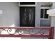 Home's front entrance featuring a decorative gate and double doors with an elegant scrollwork design at 197 E Shelbourne Ave, Las Vegas, NV 89123