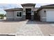 Inviting single-story home featuring a tiled walkway, arched entrance, dual lanterns and gated entry at 197 E Shelbourne Ave, Las Vegas, NV 89123