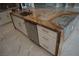Luxurious kitchen island features a marble countertop, sink, dishwasher, and white cabinets, all beautifully illuminated at 197 E Shelbourne Ave, Las Vegas, NV 89123