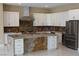 Spacious kitchen features a center island, ample cabinet space, stone countertops, and stainless steel appliances at 197 E Shelbourne Ave, Las Vegas, NV 89123