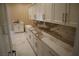 Mud room with white cabinets, marble countertops, and a sink at 197 E Shelbourne Ave, Las Vegas, NV 89123