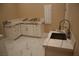 Mud room with white cabinets, marble countertops, and a stainless steel sink at 197 E Shelbourne Ave, Las Vegas, NV 89123