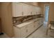 Mud room with white cabinets and marble countertops at 197 E Shelbourne Ave, Las Vegas, NV 89123