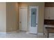 Bright pantry area with white cabinets and a decorative glass door for food storage at 197 E Shelbourne Ave, Las Vegas, NV 89123