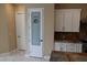 Bright pantry area with white cabinets and a decorative glass door for food storage at 197 E Shelbourne Ave, Las Vegas, NV 89123