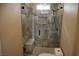 Luxurious shower with a built in seat and stone tile at 197 E Shelbourne Ave, Las Vegas, NV 89123