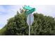 The Gillespie and Shelbourne street sign is framed by lush green bushes on a clear day at 197 E Shelbourne Ave, Las Vegas, NV 89123