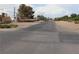 Street view showcases a residential area with a paved road, landscaping and scattered buildings under cloudy sky at 197 E Shelbourne Ave, Las Vegas, NV 89123