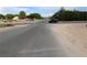 Street view with a blue car driving down a smooth, grey asphalt street with vegetation on both sides at 197 E Shelbourne Ave, Las Vegas, NV 89123