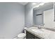 Powder room featuring granite countertops and a decorative framed mirror at 2062 Club Crest Way, Henderson, NV 89014