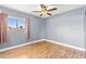 Bedroom featuring hardwood floors, ceiling fan, and bright window at 2062 Club Crest Way, Henderson, NV 89014