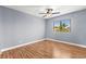 Bedroom with hardwood floors, ceiling fan, and bright window view at 2062 Club Crest Way, Henderson, NV 89014