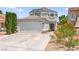 Inviting two-story home with a well-maintained lawn and a two car garage at 2062 Club Crest Way, Henderson, NV 89014