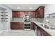 Modern kitchen with stainless steel appliances, granite countertops, and tile backsplash at 2062 Club Crest Way, Henderson, NV 89014