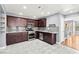 Modern kitchen boasts dark cabinetry, granite countertops, and stainless steel appliances at 2062 Club Crest Way, Henderson, NV 89014