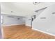 Large living room with wood floors leading to staircase, dining area and windows at 2062 Club Crest Way, Henderson, NV 89014