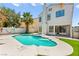 Sparkling pool and jacuzzi in a private backyard with stucco walls and a grass area at 2062 Club Crest Way, Henderson, NV 89014