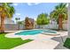 Backyard featuring a refreshing pool and spa with lush landscaping at 2062 Club Crest Way, Henderson, NV 89014