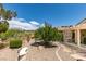 A stone bench and gravel create a low-maintenance, drought-resistant backyard oasis at 2120 Desert Woods Dr, Henderson, NV 89012