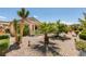 A serene backyard showcasing desert landscaping, decorative rocks, and charming plants at 2120 Desert Woods Dr, Henderson, NV 89012