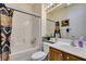 Bathroom with a shower-tub combo, patterned shower curtain, and a white vanity at 2120 Desert Woods Dr, Henderson, NV 89012
