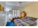 Cozy bedroom features a large window with shutters and yellow and white walls at 2120 Desert Woods Dr, Henderson, NV 89012