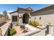 Private courtyard offers a tranquil outdoor space with a dining set, charming desert landscaping, and gated entry at 2120 Desert Woods Dr, Henderson, NV 89012