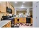 Well-maintained kitchen offering oak cabinets, black appliances, and plenty of counter space with an open layout at 2120 Desert Woods Dr, Henderson, NV 89012