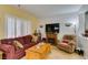 Comfortable living room with a fireplace, plantation shutters, and wood laminate flooring at 2120 Desert Woods Dr, Henderson, NV 89012