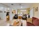 Spacious living room with open layout into kitchen, wood laminate flooring, and built-in shelving at 2120 Desert Woods Dr, Henderson, NV 89012