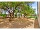 Spacious backyard featuring mature trees, providing shade and privacy, with low-maintenance gravel landscaping at 2227 Garden City Ave, Henderson, NV 89052