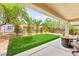 Serene backyard with manicured lawn, palm trees, and an outdoor seating area for relaxation at 2227 Garden City Ave, Henderson, NV 89052