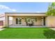 Lush backyard features an expansive lawn, shaded patio, and outdoor seating for entertaining at 2227 Garden City Ave, Henderson, NV 89052