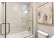 Bright bathroom features a glass-enclosed shower with marble-like tile and modern fixtures at 2227 Garden City Ave, Henderson, NV 89052