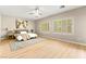 Spacious bedroom featuring light-toned wood floors, ceiling fan, and large windows with plantation shutters at 2227 Garden City Ave, Henderson, NV 89052