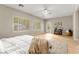 Large bedroom with plush rug, ceiling fan, plantation shutters, and door leading to the backyard at 2227 Garden City Ave, Henderson, NV 89052