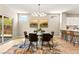 Contemporary dining room boasts modern light fixture, stylish decor and sliding door access to outdoor space at 2227 Garden City Ave, Henderson, NV 89052