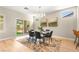 Dining room with modern table and chairs, stylish rug, and sliding glass door to the backyard at 2227 Garden City Ave, Henderson, NV 89052